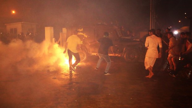 Iraqi riot police spray water and tear gas at the protesters.