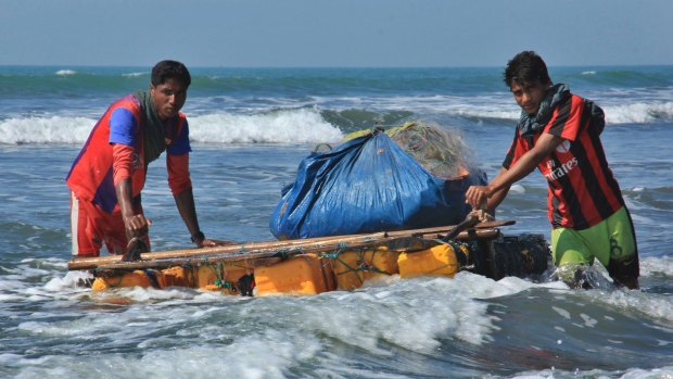 Rohingya fishermen pull a raft made of empty plastic containers along the coastline of the Bay of Bengal in Maungdaw, western Rakhine state after fishing boats were outlawed s part of a counter-insurgency campaign.