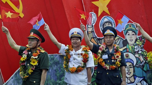 Vietnamese military personnel wave flags during a parade celebrating the 40th anniversary of the end of the Vietnam War  last year. 