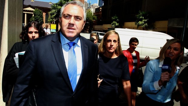 Treasurer Joe Hockey leaves court during the defamation case against Fairfax Media.