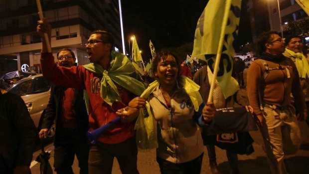 Alianza PAIS supporters celebrate in the streets.