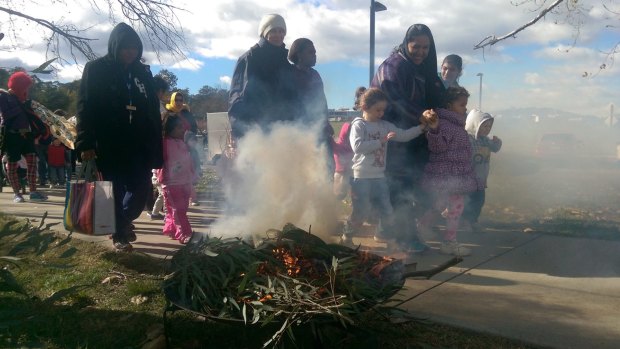 Hundreds walked across Commonwealth Bridge in Canberra on Friday to mark National Sorry Day. Smoke marked the start of the walk from Regatta Point.