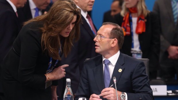 Listen up: Tony Abbott gets advice from Peta Credlin. One Liberal MP has accused her of 'poisoning the Prime Minister about all his members.'