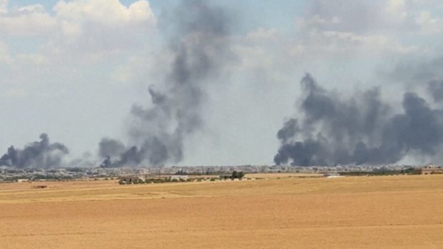 Smoke rises from the city of Manbij, Syria in June.