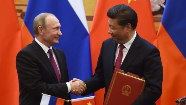 Russian President Vladimir Putin shakes hands with Chinese President Xi Jinping during a signing ceremony in Beijing's Great Hall of the People.