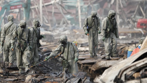 Rescuers spray hydrogen peroxide at the site of Tianjin warehouse explosion.