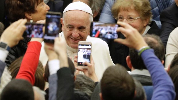 Pope Francis exchanges Christmas greetings with Vatican employees.