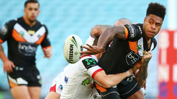 Flair: Kevin Naiqama of the Tigers offloads against the Dragons.