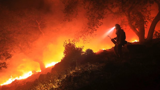 A firefighter monitors a flare up in Sonoma, California.