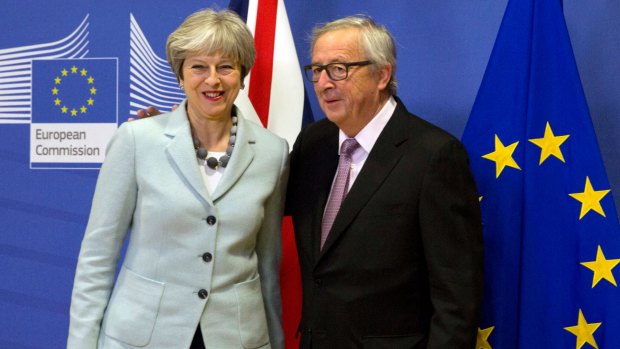 British PM Theresa May is greeted by European Commission President Jean-Claude Juncker ahead of a meeting at EU headquarters in Brussels.