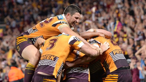 On a roll: Broncos players celebrate at the final whistle.