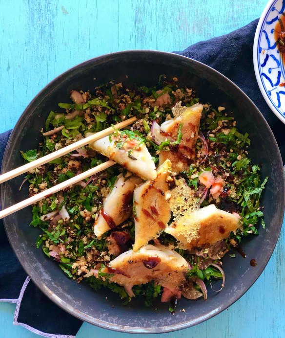 Lacy potsticker dumplings on a bed of roasted cauliflower, herb and pickled ginger salad.