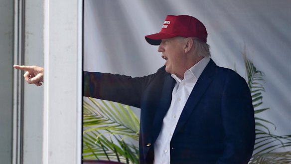 President Donald Trump reacts to spectators as he watches the third round of the US Women's Open Golf tournament in Bedminster, New Jersey, on Saturday