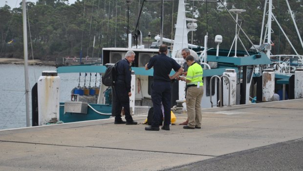 Alan Langdon speaks with Australian Border Force officials at Ulladulla Harbour.