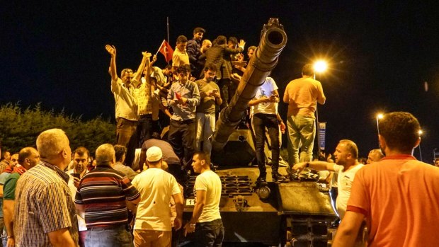 Protesters on top of a Turkish army tank at Ataturk Airport on Friday night.