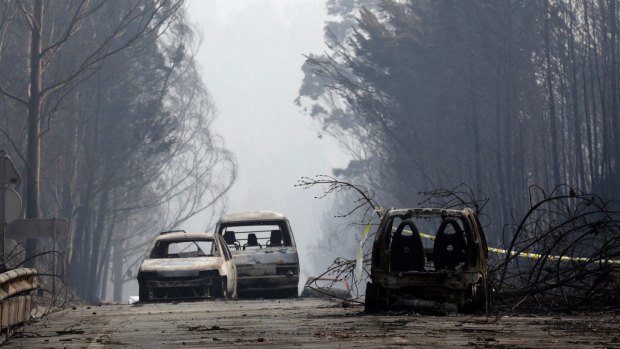 Burnt cars block the road between Castanheira de Pera and Figueiro dos Vinhos. More than 50 people were killed in what the prime minister called "the biggest tragedy of human life that we have known in years."