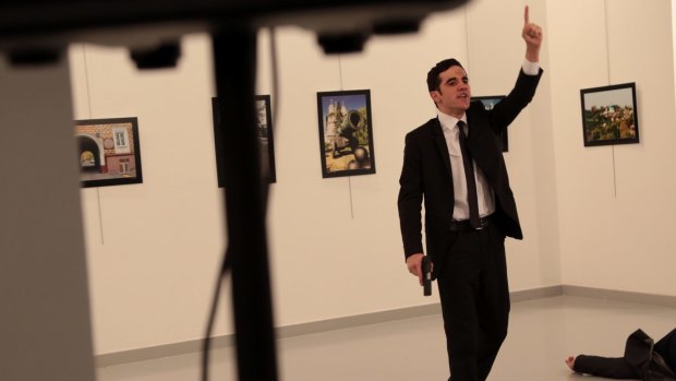 A man with a gun shouts inside the Ankara gallery as Russian ambassador to Turkey Andrei Karlov lies on the ground.