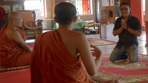 Gambira, right, at a temple in Chiang Mai, last year. The former monk was a volunteer teacher at the local temple, providing lessons to migrant workers and their families.
