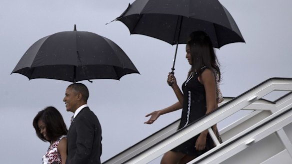 President Barack Obama, arrives with first lady Michelle Obama, left, and their daughters Sasha, front right, and Malia.
