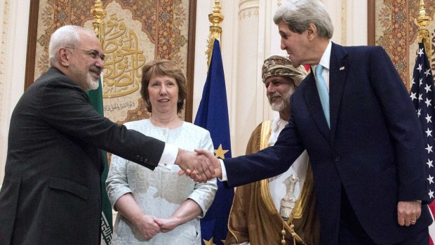 US Secretary of State John Kerry (right) and Iranian Foreign Minister Mohammad Javad Zarif shake hands in Oman as EU envoy Catherine Ashton and Omani Foreign Minister Yussef bin Alawi look on.