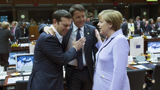 A lighter moment .. Greek Prime Minister Alexis Tsipras (left), Italian Prime Minister Matteo Renzi (centre) and German Chancellor Angela Merkel talk at a European Union leaders summit in Brussels, Belgium.