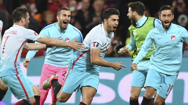 Turkey's Ozan Tufan, centre, celebrates after scoring his side's second goal.