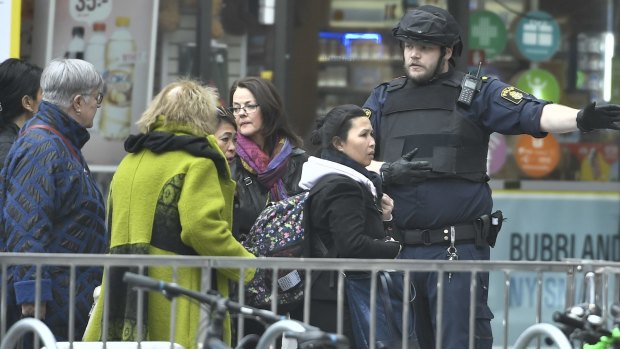How you see terrorism in Sweden may say a lot about your world view. Pictured: People guided along the street after a truck crashed into a department store in central Stockholm, Sweden on April 7. 