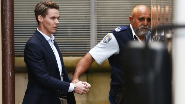 Convicted insider trader Oliver Curtis being escorted to a prison truck in June.