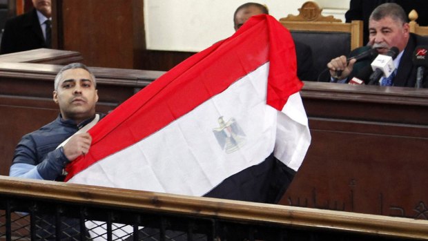 Al-Jazeera journalist Mohamed Fahmy raised an Egyptian flag in court.
