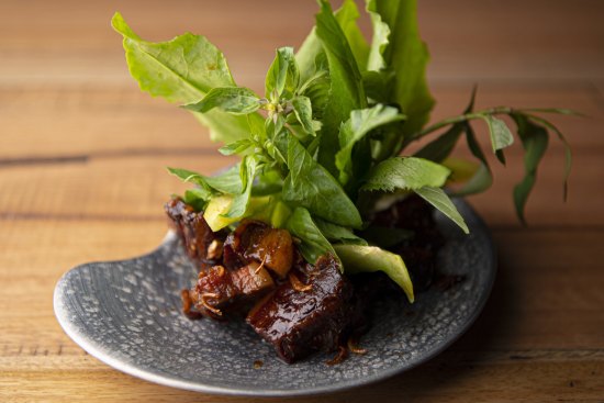 Sticky aged pork surrounded by fresh Thai herbs and leaves. 