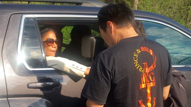 'You know he really took care of himself. He ate well. He ate better than me' ... Former Prince drummer Sheila E consoles a fan as she leaves Paisley Park estate near Minneapolis.