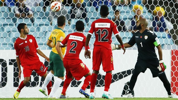 Breakthrough: Matt McKay scores the Socceroos' opening goal against Oman.