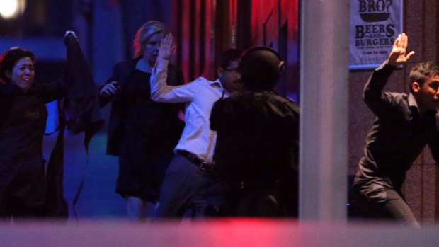 Hostages flee after police raided the Lindt cafe.