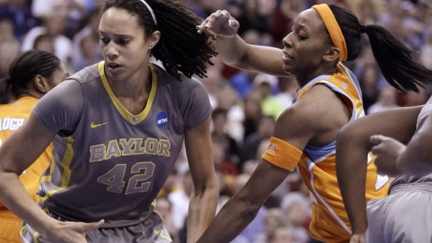 On court together: Brittney Griner (left) grabs a rebound in front of Glory Johnson during an NCAA college basketball tournament in 2012.