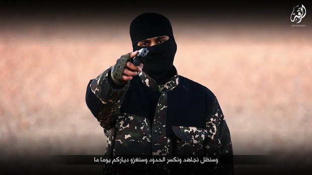 An image purporting to show an Islamic State member brandishing a gun from a video posted online by Communications Arm of Islamic State.