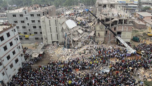 Bangladeshi people gather as rescuers look for survivors and victims at the site of the Rana Plaza collapse in April 2013.
