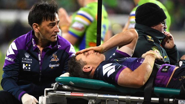 Billy Slater of the Storm is carried off after being knocked out by Sia Soliola.