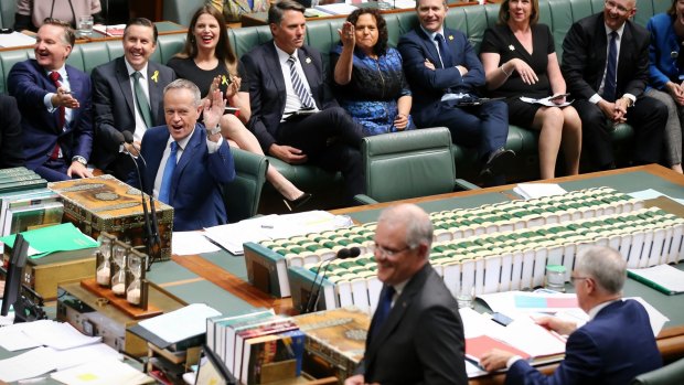 Opposition Leader Bill Shorten and his frontbench react to Treasurer Scott Morrison and Prime Minister Malcolm Turnbull during question time.
