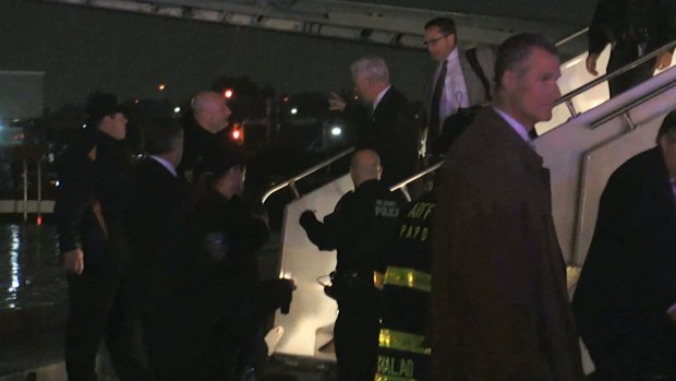 Republican vice-presidential candidate Mike Pence walks down the steps of his campaign plane at New York's LaGuardia Airport after it slid off the runway.