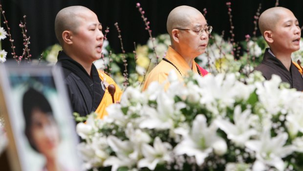 Monks chant during a public funeral for the Lin family at Sydney's Olympic Park in 2009.
