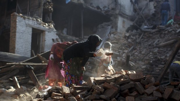 Residents clear the rubble from their homes which were destroyed after last week's earthquake in Bhaktapur, Nepal.