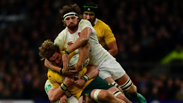 Michael Hooper of Australia (L) is tackled by Tom Wood of England (R) during the Old Mutual Wealth Series match between England and Australia at Twickenham.