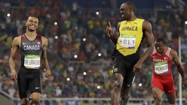 Usain Bolt wags his finger at Canadian runner Andre de Grasse.