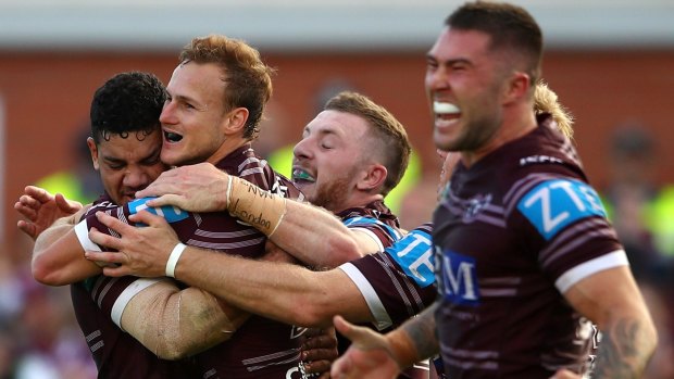 Daly Cherry-Evans celebrates with Manly teammates after the Sea Eagles' golden-point win.