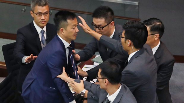 Lawmaker Raymond Chan Chi-chuen tries to break through the security guards during the election of president of the Legislative Council in Hong Kong.