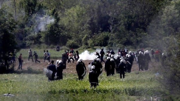 Riot: Greek police deploy along the border with Macedonia.