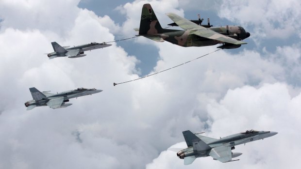 A Singapore C-130 Hercules tanker refuels F/A-18 Hornets from Australia's 3 Squadron during exercises in 2009.