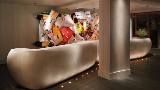 A sculpture of broken surfboards lends a burst of colour to the reception at the Modern Honolulu.