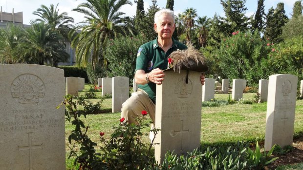 Austin Short at the grave of his grandfather, Howard Taylor, in Haifa, northern Israel.
