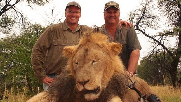 Walter Palmer, left,  posed with the corpse of Cecil the lion and an unidentified man, after hunting and wounding him with his bow, and shooting him 40 hours later.